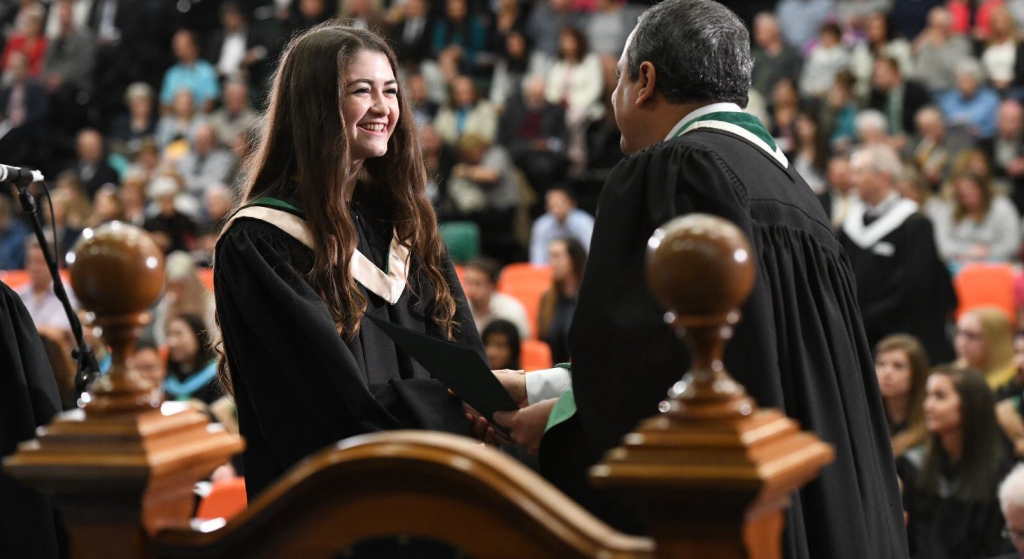 A student accepts her degree