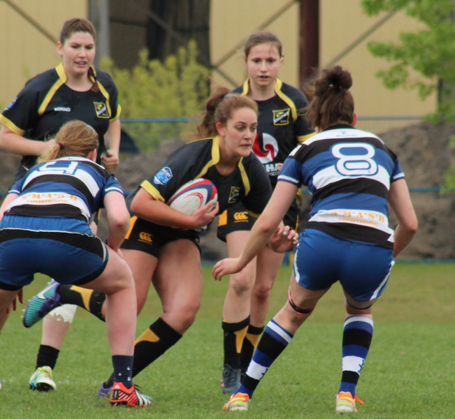 A group of young women playing rugby