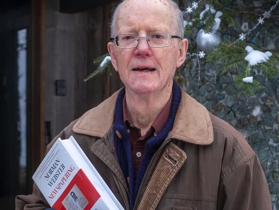 photo of man holding a book