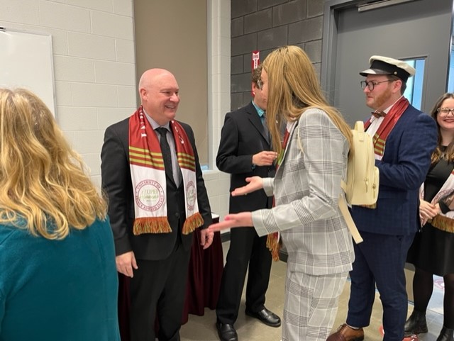 Dr. Greg Keefe, UPEI interim president and vice-chancellor, greets former UPEI Student Union presidents Emma Drake and Will McGuigan at UPEI's 2023 New Year's Day Levee.