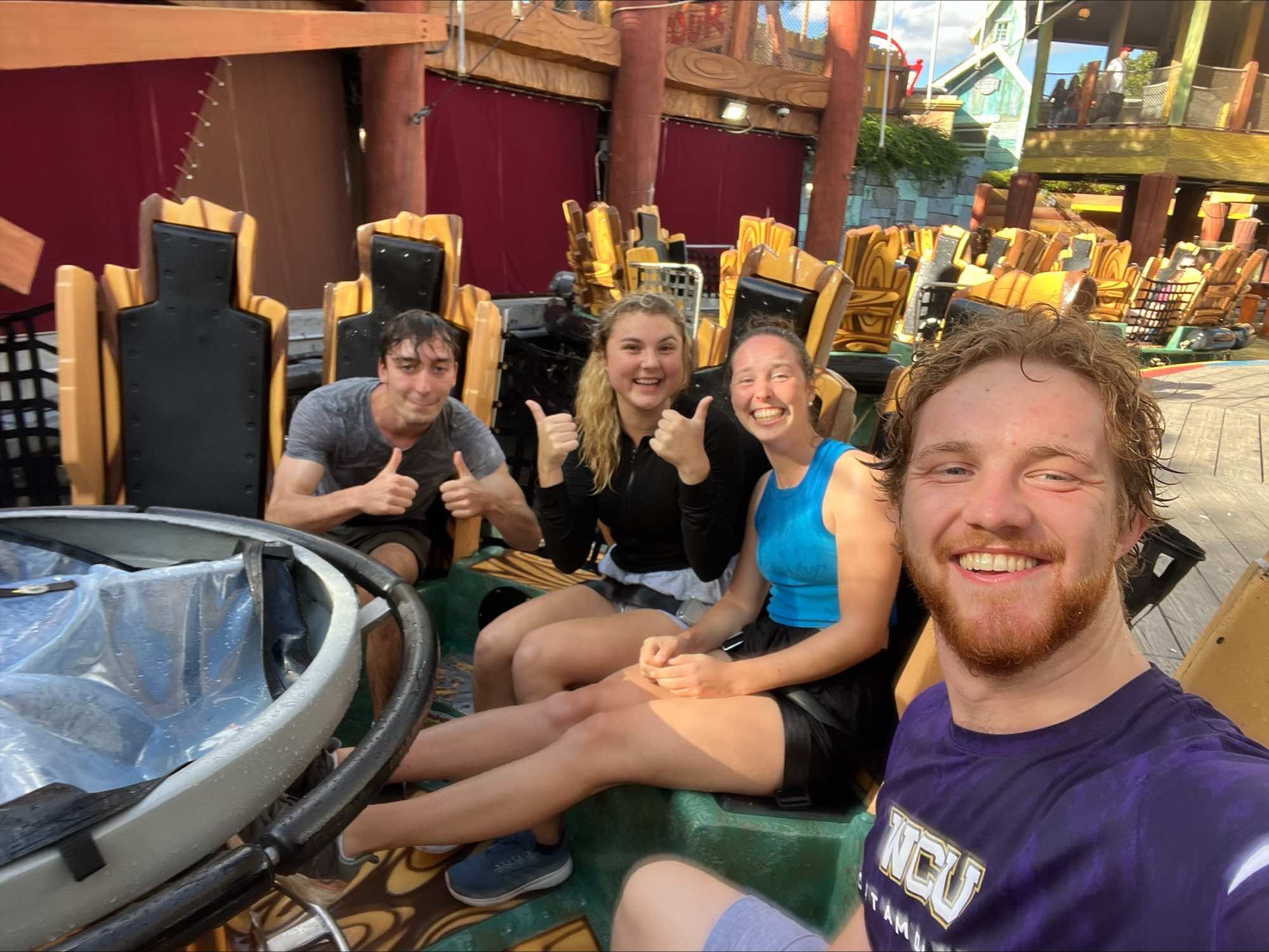 a group of four people on an amusement park ride