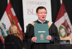Photo of 2019 UPEI graduate after he has received his degree.
