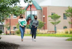 Students wearing masks stroll on the UPEI campus.
