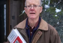 photo of man holding a book