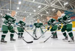group photo of five women hockey players holding their sticks