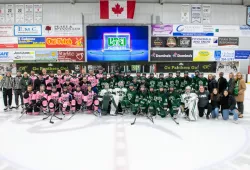 The UPEI faculty-staff team and the UPEI Women’s Hockey Panthers pose for a photo with their coaches and referees