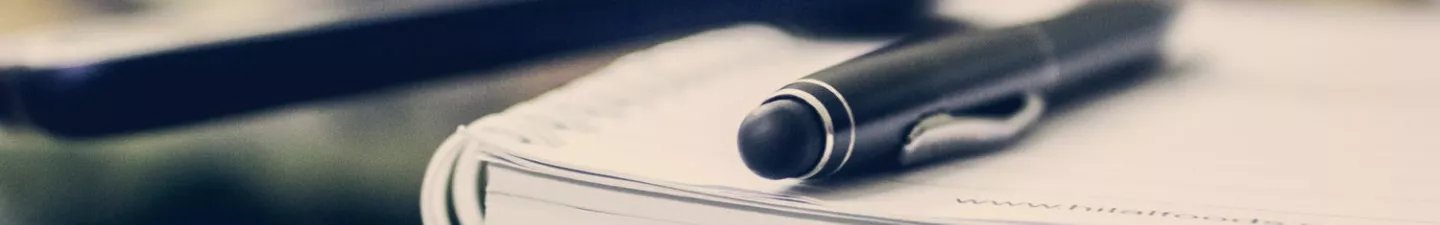 a fountain pen on a notebook