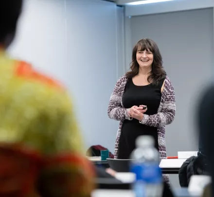 a facilitator smiling talking to a group