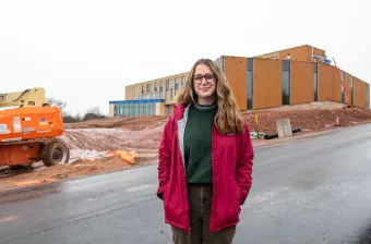 UPEI climate change student Zoe Furlotte outside the Canadian centre for climate change and adaptation building during construction