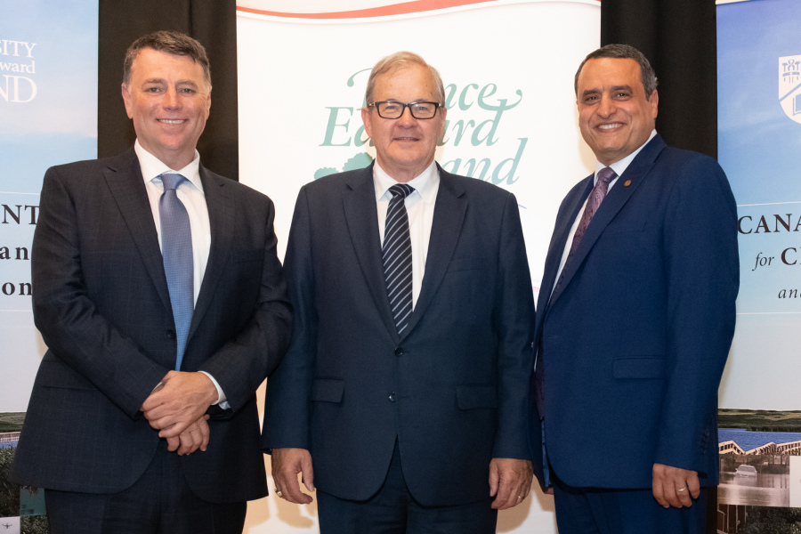 three smiling men in suits