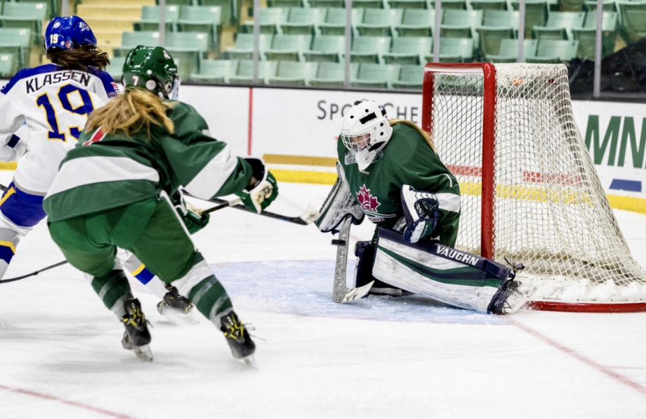Shaylin McFarlane A goalie makes a save in an ice hockey game