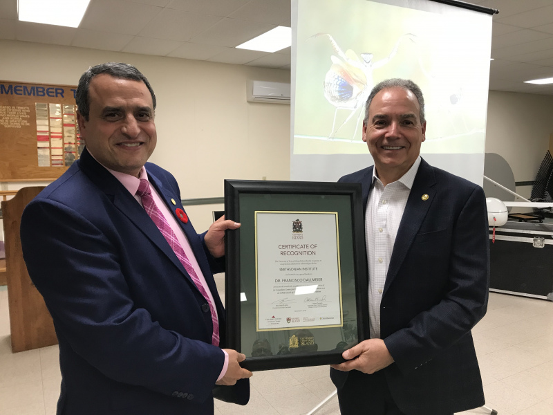 Dr. Alaa Abd-El-Aziz, UPEI's President and Vice-Chancellor, presented Dr. Francisco Dallmeier from the Smithsonian Institution with a certificate of recognition for his work in helping to establish UPEI's Canadian Centre for Climate Change and Adaptation and the UPEI School of Climate Change and Adaptation. Two men hold a certificate