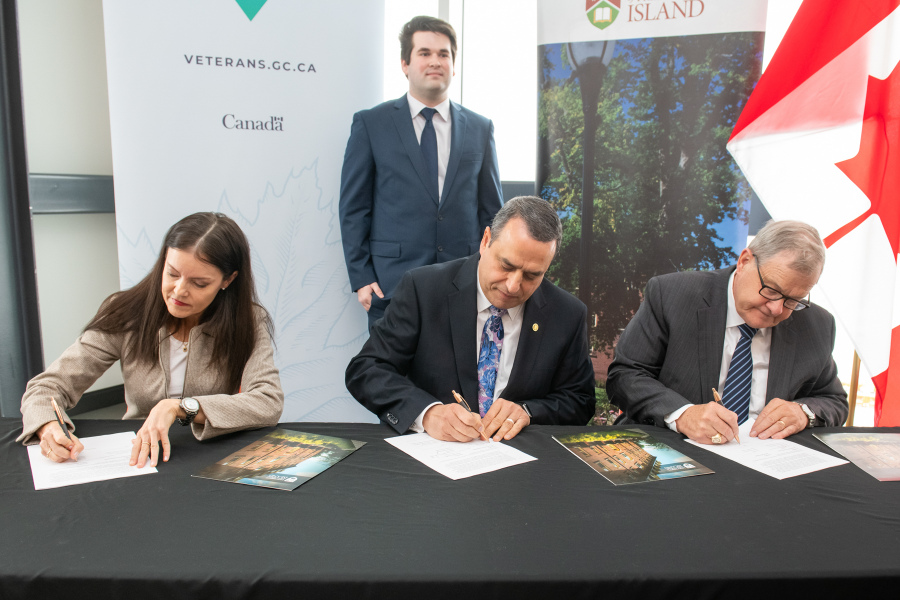 Signing a memorandum of understanding between UPEI and VAC are (left to right) Lisa Campbell, associate deputy minister, VAC; UPEI President and Vice-Chancellor Dr. Alaa Abd-El-Aziz; and the Hon. Lawrence MacAulay, Minister of VAC and Associate Minister of National Defence. Looking on is Devon Clark, student ambassador for UPEI and VAC.   