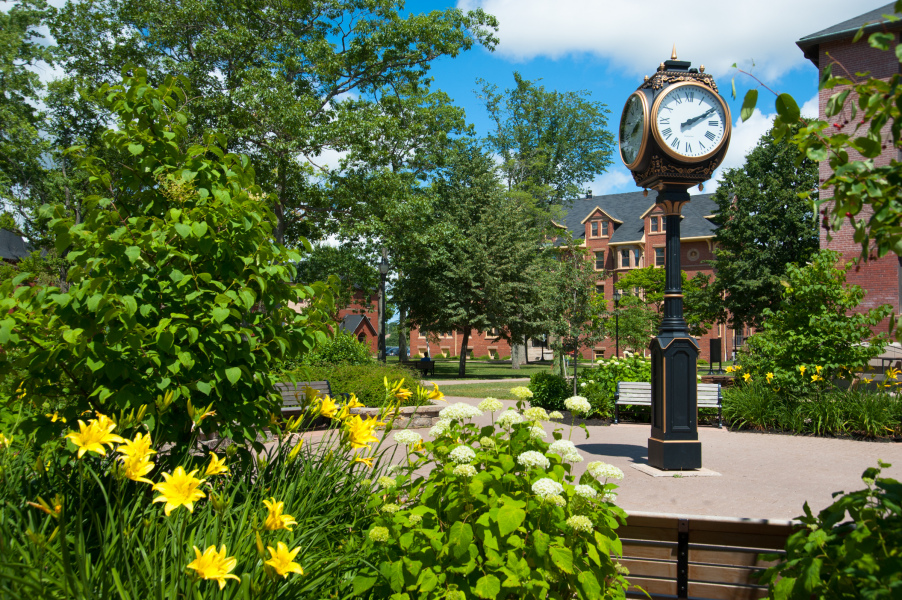 The clock at the centre of UPEI's campus surrounded by summer foliage