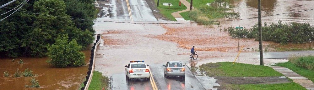 A river floods over a highway 