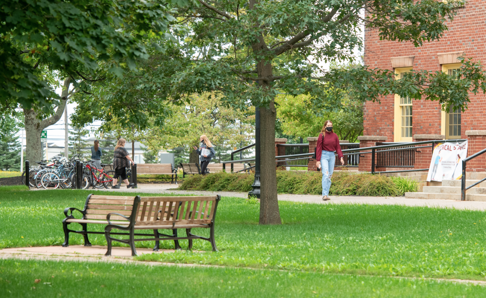 image of student wearing mask in the quadrangle