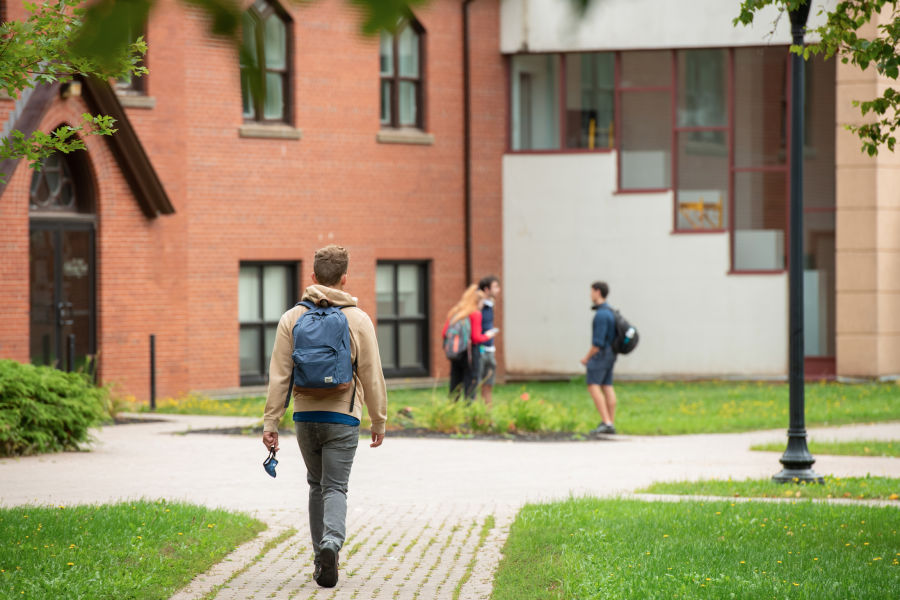 Photo of student walking in quad