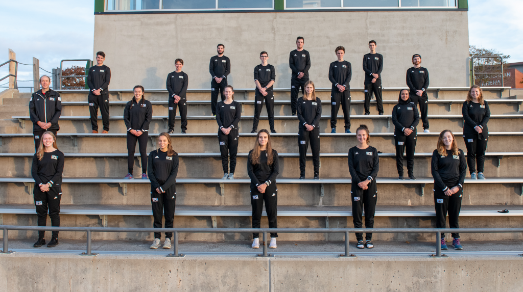 UPEI's Cross Country team A group of male and female student athletes standing in formation on a set of bleacher seats