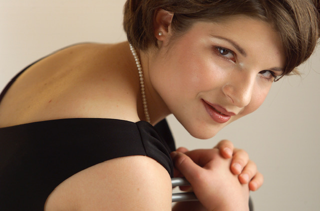 A female with dark hair in formal black dress 