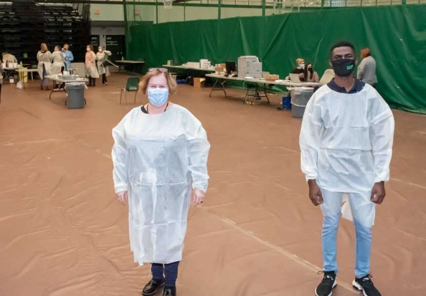 Health and Wellness Centre director Marilyn Barrett, at left, stands with fourth-year business student and clinic volunteer Ekene Nicholas Onyeagolum, just before the clinic opened on December 10 photo of pop-up testing clinic