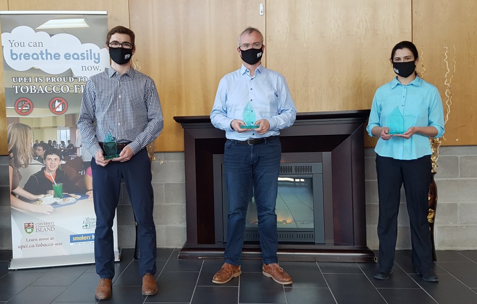 Tyler Gallant, 2020 Business Co-op Student of the Year; Pat Dorsey, vice-president, Atlantic Canada Opportunities Agency PEI & Tourism, 2020 Co-op Employer of the Year; and Desiree Rehel, 2020 Science Co-op Student of the Year Two men and a woman stand in a line, spaced out for social distancing, wearing masks.