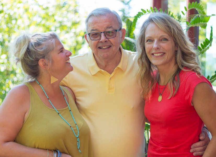 Mo Duffy Cobb, Dr. Regis Duffy, Lori Mayne Two smiling women flank a smiling older man no a sunny day. All look happy and relaxed.