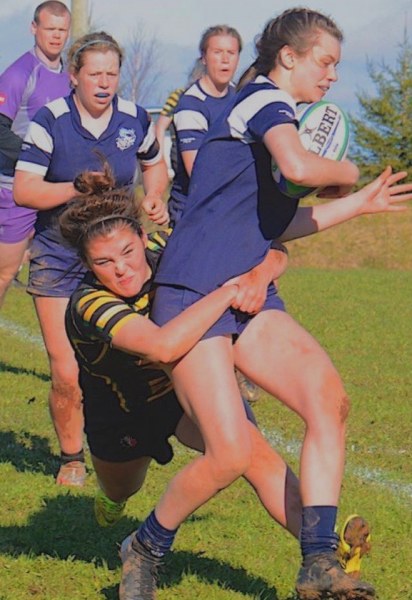 Emily McKenna tackles a Bluefield player in PEI School Athletics Association action (Photo by Jason Malloy, The Guardian, Saltwire) Picture of woman rugby player tackling another who is carrying ball with teammates looking on