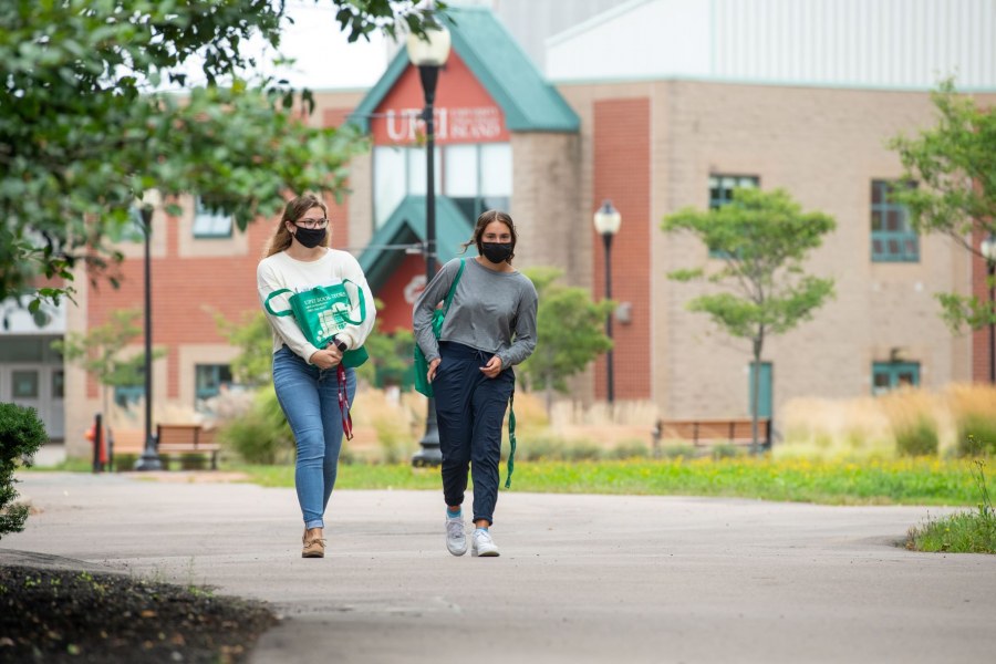 Students wearing masks stroll on the UPEI campus.