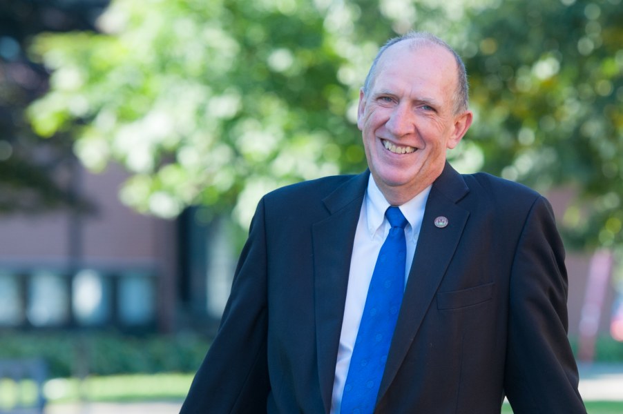Dr. James Randall A smiling older man in a suit