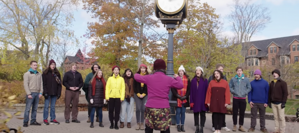A small chamber choir sings outside on UPEI campus