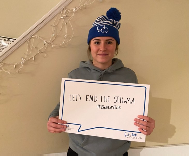 UPEI Women's Hockey Panther Camille "Schugs" Scherger is a mental health advocate who has created the "Saves for Mental Health" fundraiser photo of young woman wearing toque and holding thought bubble placard