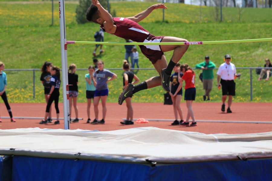 image of athlete jumping over bar in high jump competition