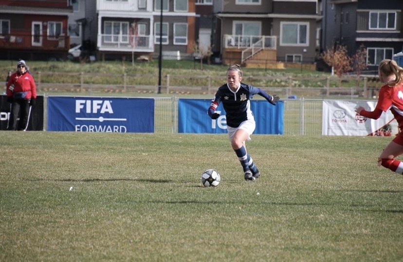 Photo: Searletown, PEI's Lydia Hamill will be donning the green and white for the UPEI Women's Soccer Panthers photo of woman dribbling soccer ball on a grass pitch