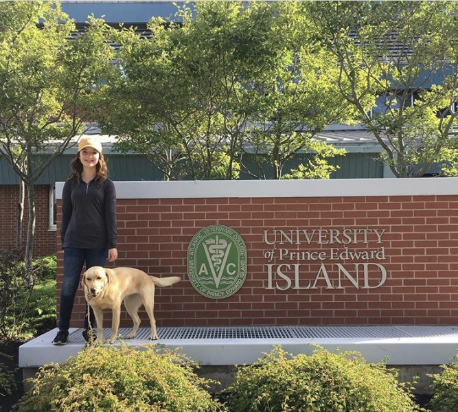 Eva MacNeill poses outside of the Atlantic Veterinary College during Open House, a tradition she has held since she was five years old. 