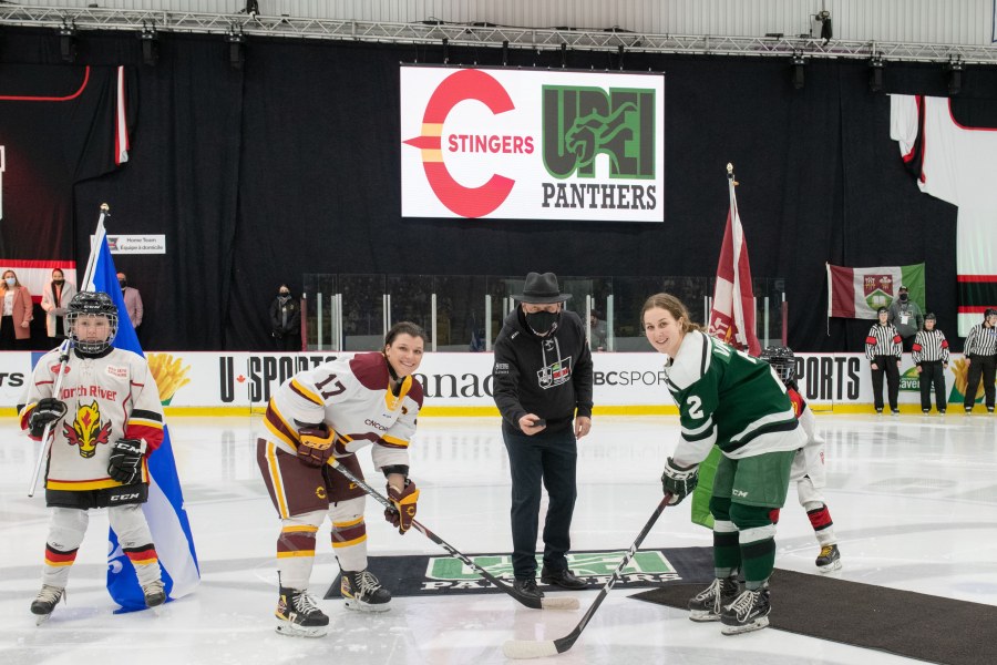 photo of man dropping the ceremonial puck at women's hockey game