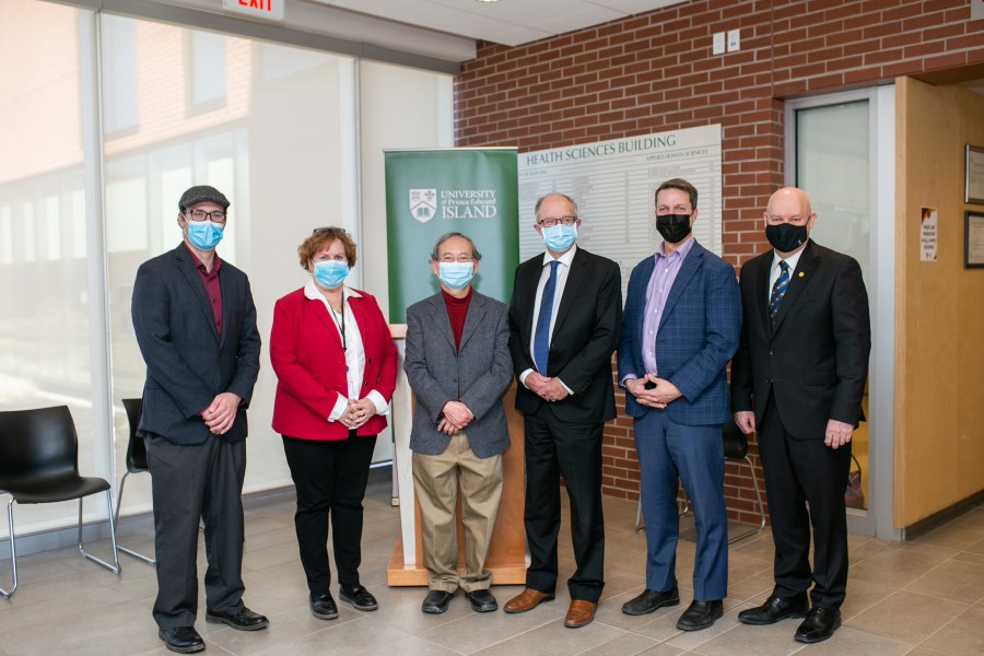 From L to R: Sandy Slade, Marilyn Barrett, Dr. David Wong, Hon. Ernie Hudson, Hon. Brad Trivers, and Dr. Greg Keefe. group of people wearing masks