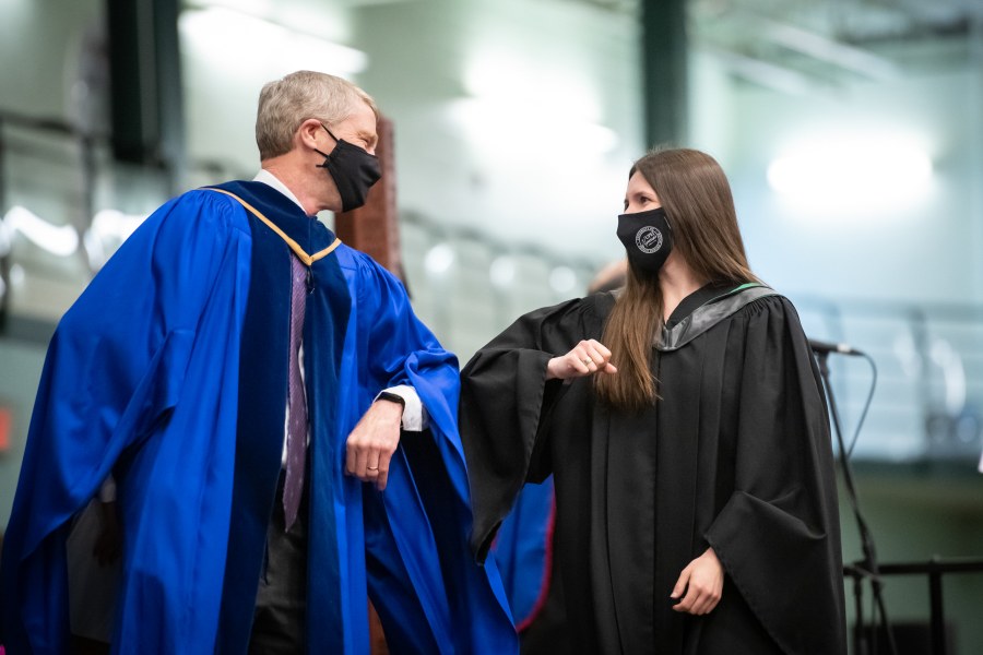 Dr. John VanLeeuwen congratulates new graduate Dr. Kaitlyn Williamson during UPEI's Convocation Ceremony.