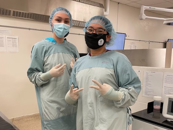 Aliyah Aglukkaq (right) poses with her friend and fellow camper Anikan Ikuallaq-Pouliot in a gowning, gloving, and suturing session during AVC Vet Camp. Aliyah Aglukkaq (right) poses with her friend and fellow camper Anikan Ikuallaq-Pouliot in a gowning, gloving, and suturing session during AVC Vet Camp.