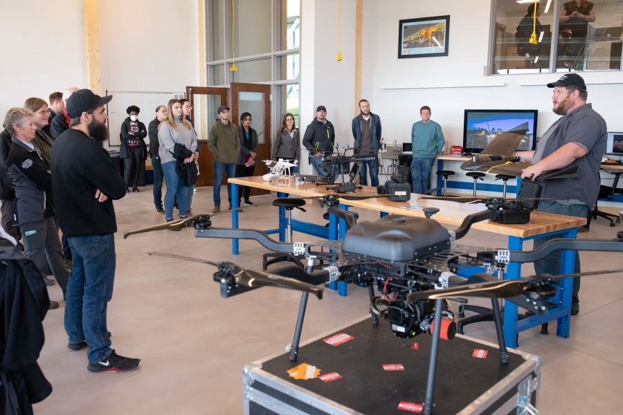 Luke Meloche, Remotely Piloted Aircraft System Pilot and Research Assistant at the UPEI Climate Lab provides information on lab’s fleet of drones to some of the Open House attendees Luke Meloche, Remotely Piloted Aircraft System Pilot and Research Assistant at the UPEI Climate Lab provides information on lab’s fleet of drones to some of the Open House attendees