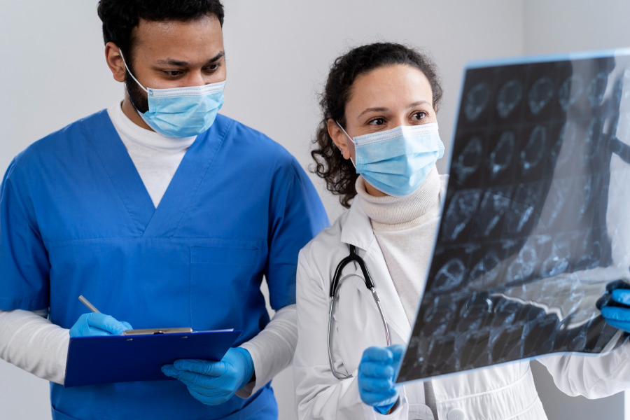 photo of health workers looking at x-ray