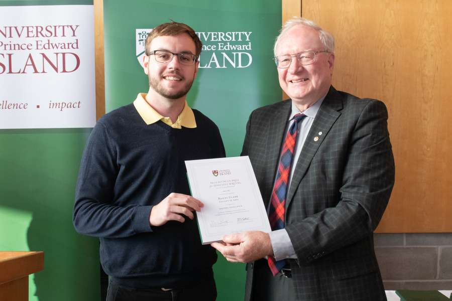 Award winner Bailey Clark accepts his certificate from President Emeritus Wade MacLauchlan Award winner Bailey Clark accepts his certificate from President Emeritus Wade MacLauchlan