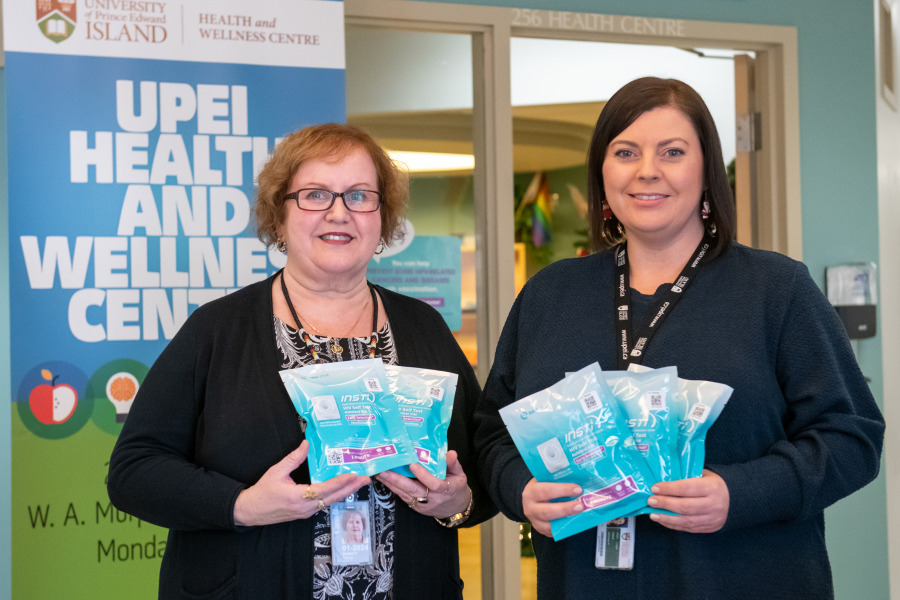 Marilyn Barrett, director of the UPEI Health and Wellness Centre, and Adrienne Fudge, RN, display HIV self-testing kits available through the I’m Ready to Know program.