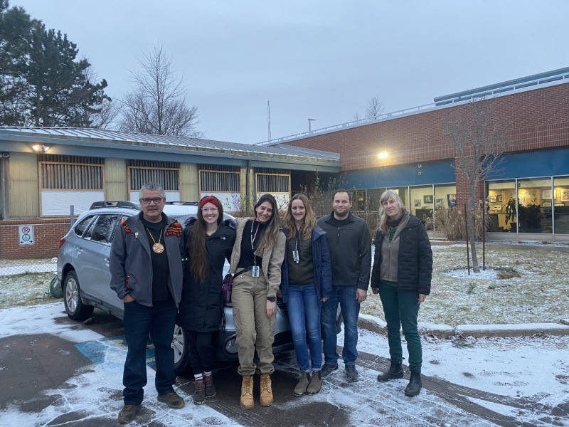 (From left to right): Elder Junior Peter Paul, Raelyn McCurdy, Dr. Giuliana Obeid, Dr. Lara Cusack, Dillon Scott, and Fiep de Bie preparing to transfer "Buddy" to Hope for Wildlife. 