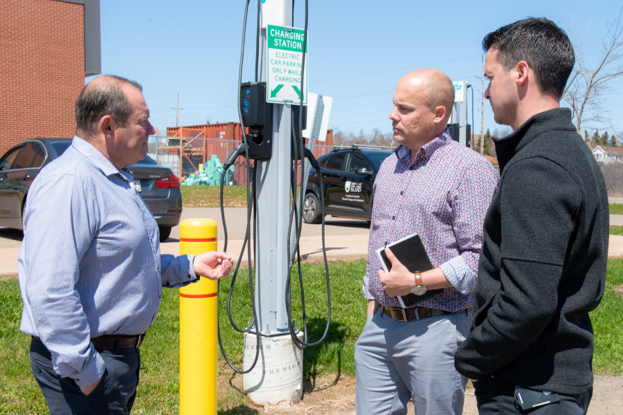 Fred Horrelt, associate vice-president facilities management and construction at UPEI, discusses the new EV chargers with Ross Dwyer, manager of research partnerships at the Canadian Centre for Climate Change and Adaptation, and Nathan MacLeod, manager of capital projects and planning at UPEI.
