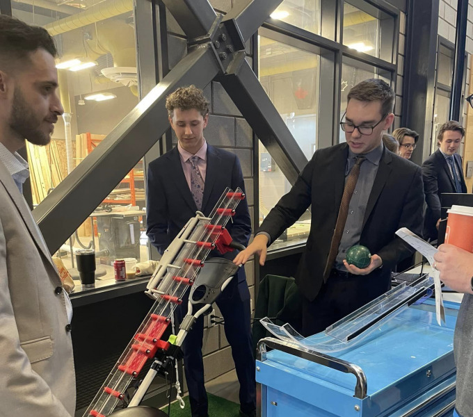 Year 2 student design team members Sami Yacoub, Spencer Blacquiere and Adam MacKenzie demonstrate their Bocce Ball Assist Ramp for Wheelchair Athletes. Their design received the OCII Award for the project that best demonstrates the potential for commercialization. Year 2 student design team members Sami Yacoub, Spencer Blacquiere and Adam MacKenzie demonstrate their Bocce Ball Assist Ramp for Wheelchair Athletes. Their design received the OCII Award for the project that best demonstrates the potential for commercialization.