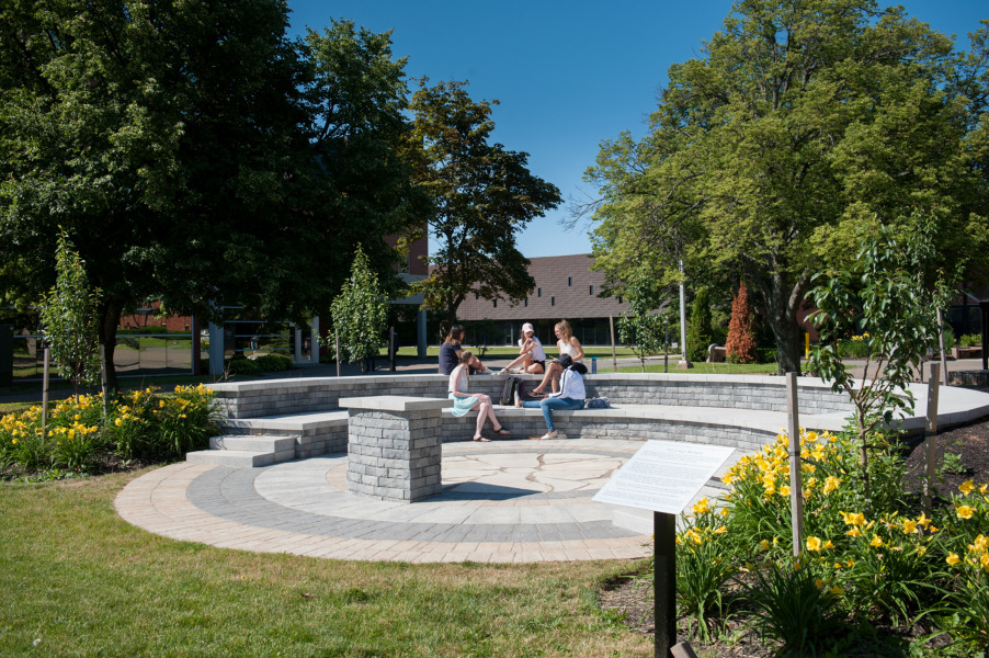 group of people sitting in outdoor amphitheatre during summer