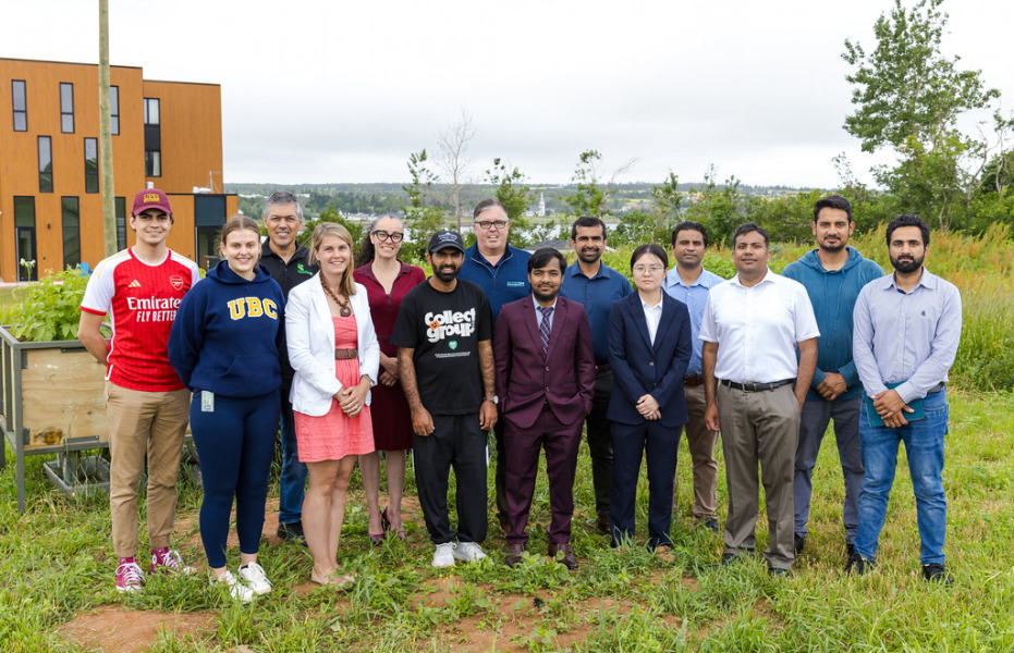 UPEI faculty, undergraduate and graduate students, and postdoctoral fellows were among those who attended the announcement of the projects funded this year through the Government of PEI’s climate challenge fund: front row (left to right): Abbey Chapman, Dr. Stephanie Shaw, Muhammad Saifullah, Nasim Mia, Dr. Yulin Hu, Saad Cheema, and Muhammad Hassan; back row (left to right): Diego Mota, Natal Antonini (Upcycle Green Technology Auto Shop), Dr. Nadja Bressan, The Honourable Steven Myers, Dr. Aitazaz Farooque, Syed Shah, and Nauman Yaqoob. The announcement took place at UPEI’s Canadian Centre for Climate Change and Adaptation on July 18. (Photo courtesy of Province of PEI) PEI Climate Challenge Fund announcement