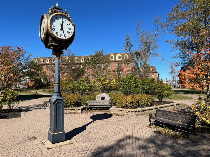 photo of clock in bricked plaza on campus