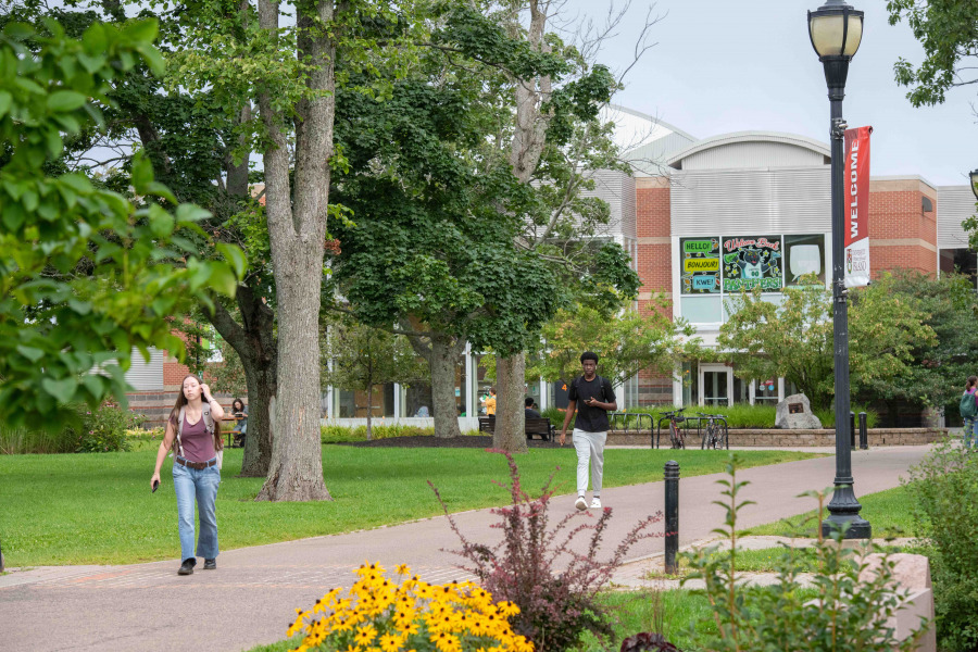 photo of students walking on campus during early fall
