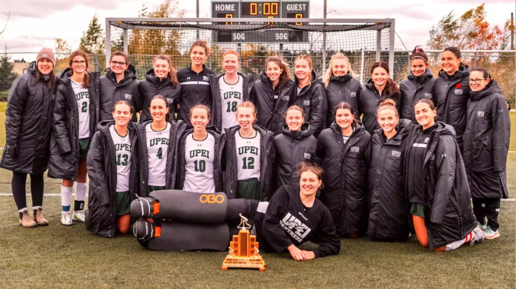 Photo credit: Philip Matusiewicz Photography photo of a group of women wearing field hockey uniforms standing on a field